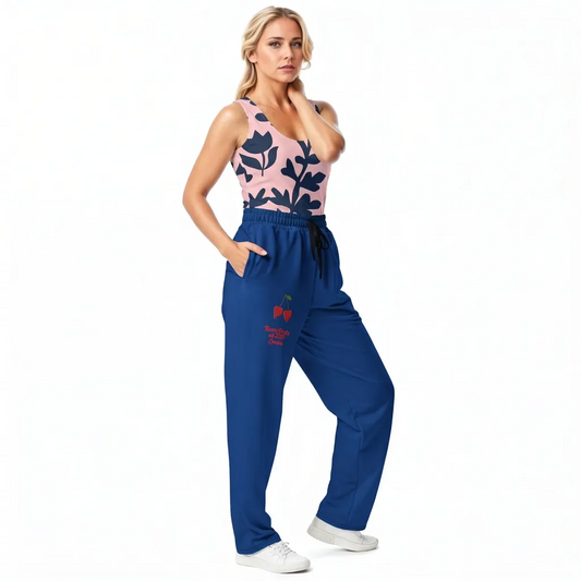 BunnyBanky AI Model wearing the Kensington Performance Tank featuring navy blue floral pattern on soft pink fabric, and the LA Flow Wide Joggers in blue with vibrant pop art duo cheries and the signature logo.