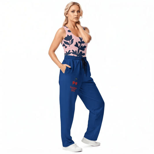 BunnyBanky AI Model wearing the Kensington Performance Tank featuring navy blue floral pattern on soft pink fabric, and the LA Flow Wide Joggers in blue with vibrant pop art duo cheries and the signature logo.