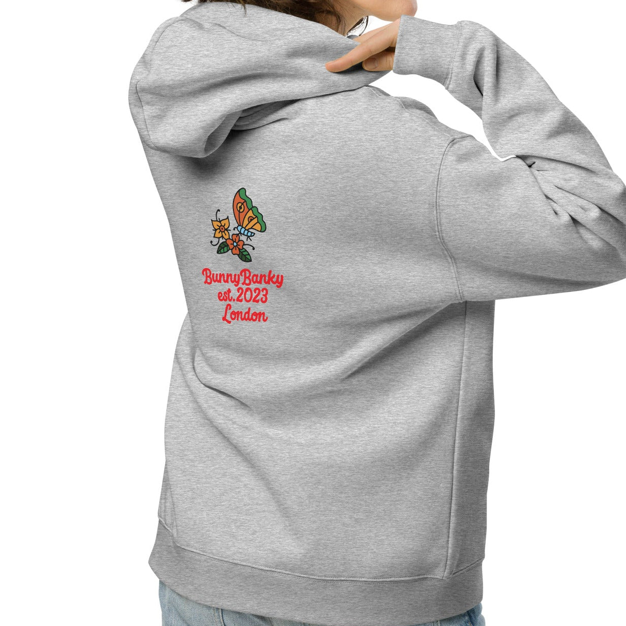 A close-up of The Chelsea Garden Hoodie's front, highlighting the detailed, colorful floral embroidery and the soft brushed-fleece fabric.