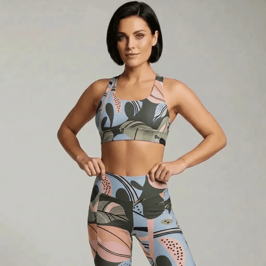 A model wearing The Barbican Sculpt Leggings, showing the sculpting fit and the pastel green and pink exotic flower print.