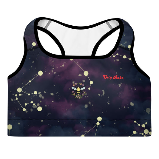 A close-up of The Andromeda Performance Bra's prints, showing the small bee and floral circle detail and the "City Babe" text printed over the fabric.