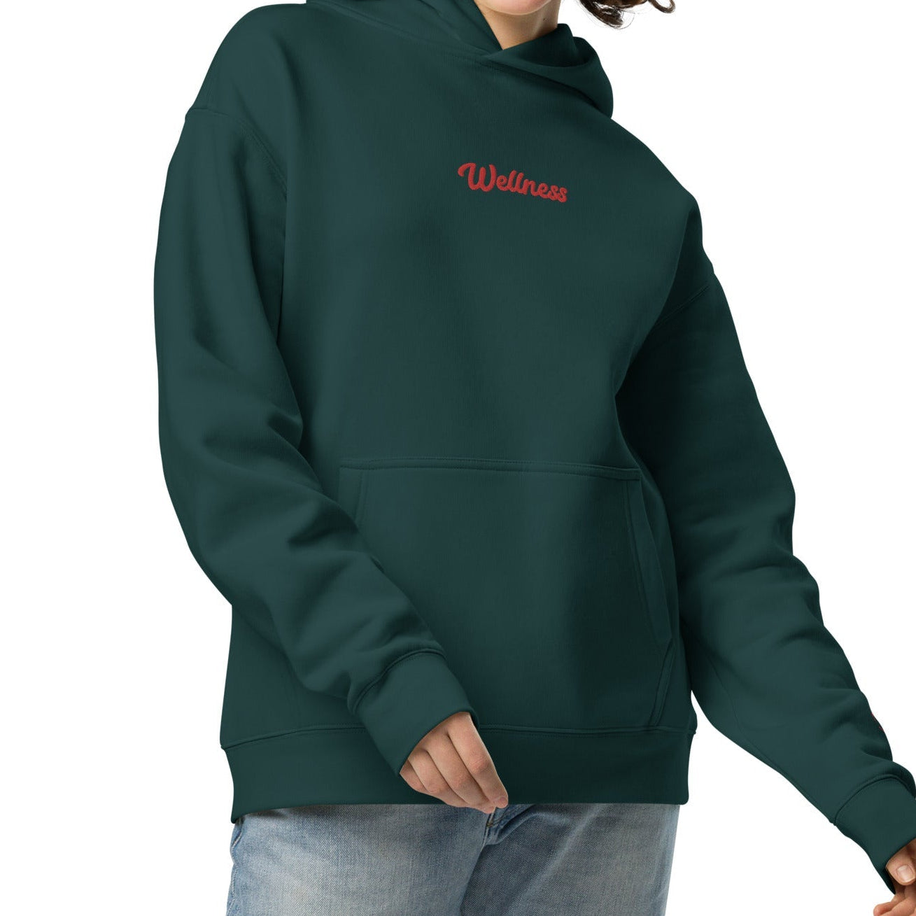 A model wearing The Angel Wellness Hoodie, showing the oversized fit and the embroidered "Wellness" text on the chest.