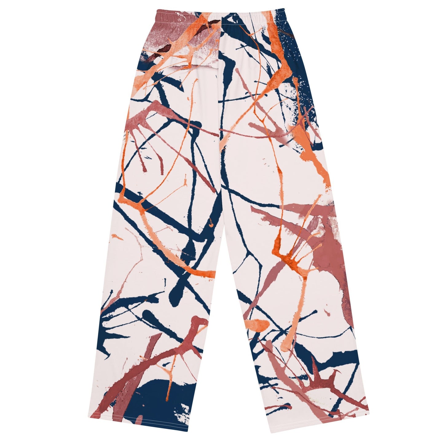 The angle flow joggers. A pair of wide-leg pants featuring an abstract paint splatter pattern in orange, navy blue, and terracotta on a light cream background, shown flat against a white background.