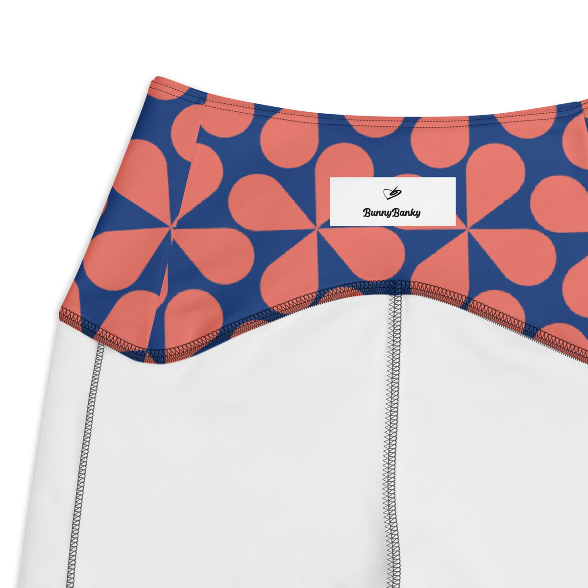 the Bakerloo Sculpt Leggings in geometric pattern in blue with coral background.