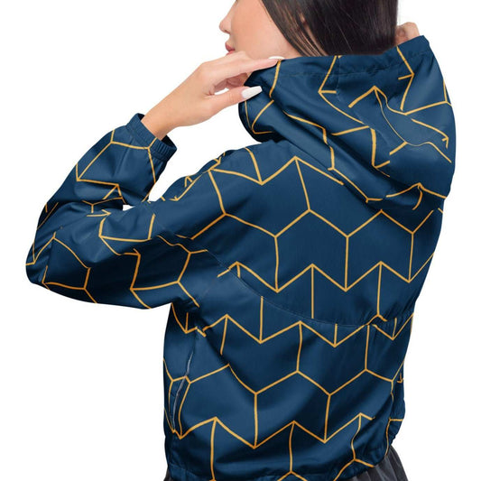 A model wearing The Baron's Court Windbreaker, showing the lightweight jacket's fit and the signature navy blue and yellow Art Deco print.