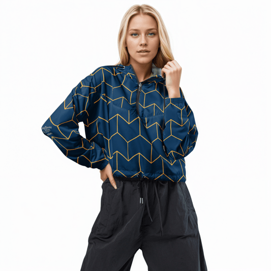 A model wearing The Baron's Court Windbreaker, showing the lightweight jacket's fit and the signature navy blue and yellow Art Deco print.