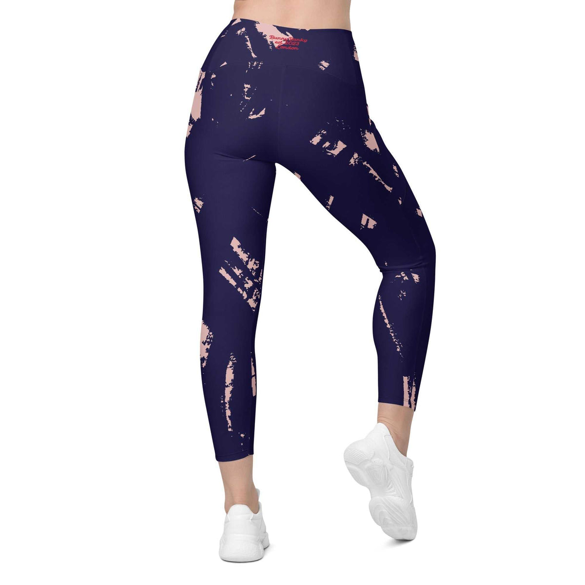 The Bristol Sculpt Leggings with black base and electric pink graffiti-style brush strokes, high-waisted with soft stretch fabric and side pockets.