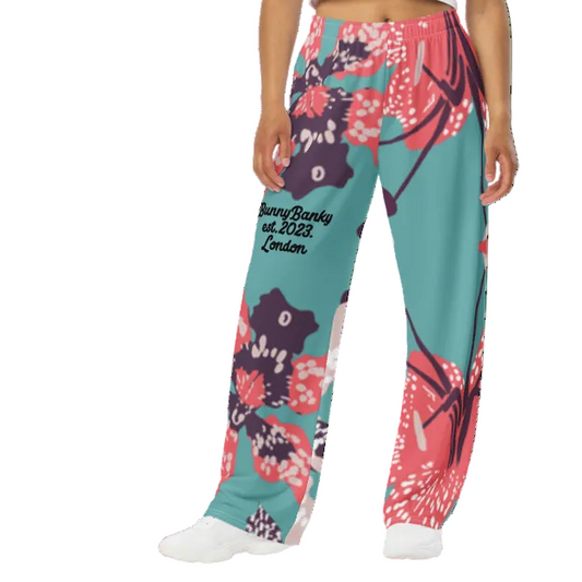 Model wearing the Chelsea Flow Joggers featuring a tropical print and heritage logo against a white background.