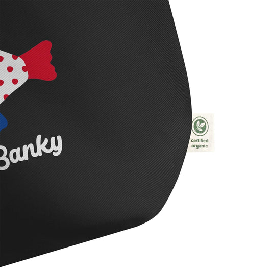 Close-up of The Coastal Tote corner with certified organic cotton label and colorful fish design