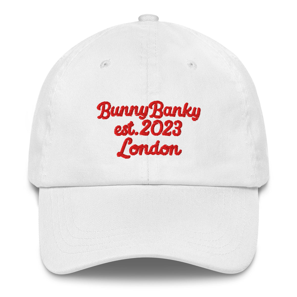 A close up of The Heritage Cap in white showing the heritage branded signature embroidered in red