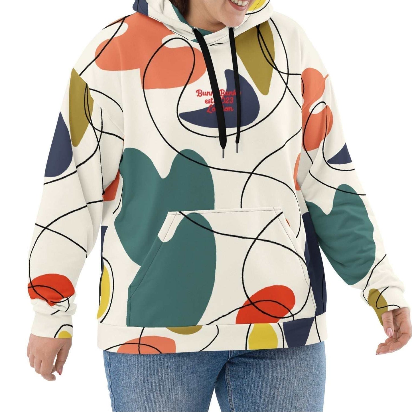 A model wearing The Joie de Vie Hoodie, showing the relaxed, oversized unisex fit and the vibrant Suprematist-inspired geometric print.