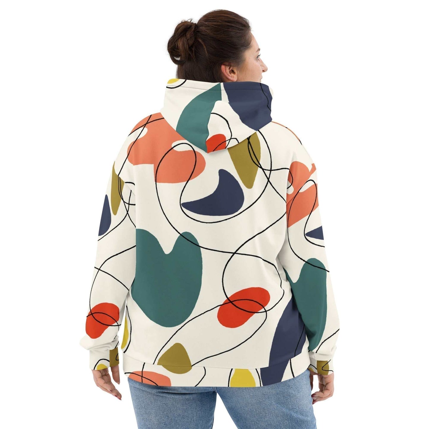 A model wearing The Joie de Vie Hoodie, showing the relaxed, oversized unisex fit and the vibrant Suprematist-inspired geometric print.