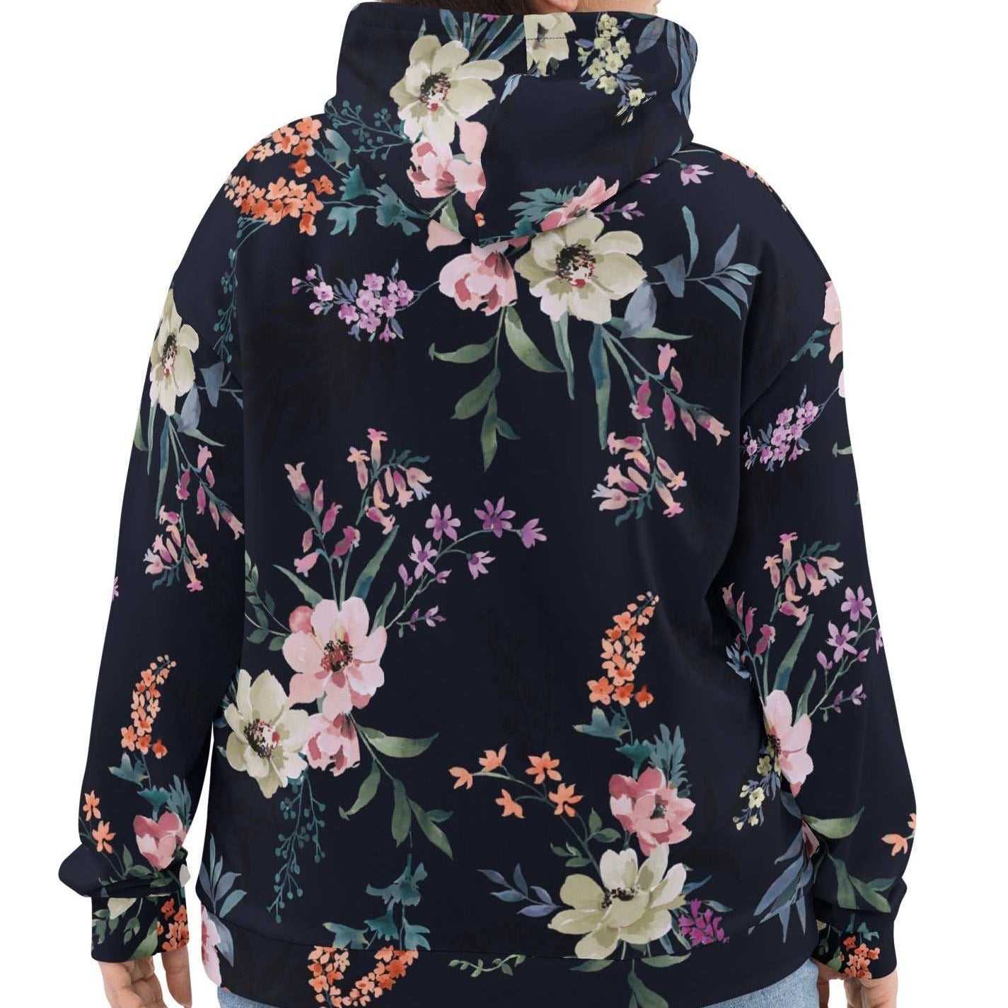 A model wearing the Kew Botanical Hoodie, highlighting the vibrant pink and violet floral details and the soft, premium drape of the recycled fabric.