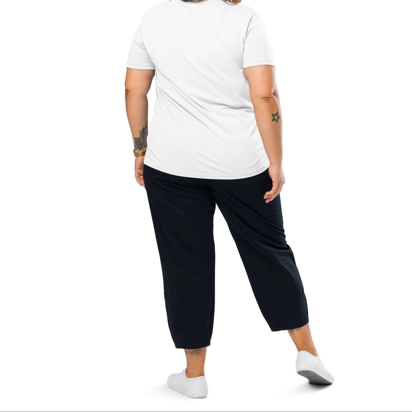 A model wearing The Manifesto Tee in 100% organic cotton, showing the "Wear the change you want to see in the world" text on the front.