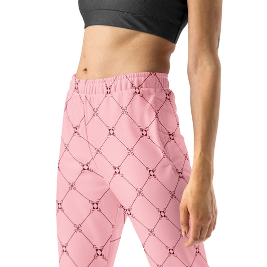 A model wearing the Mayfair Slim Fit Joggers in the burgundy and pink geometric monogram print, showing the tailored fit and secured cuffs