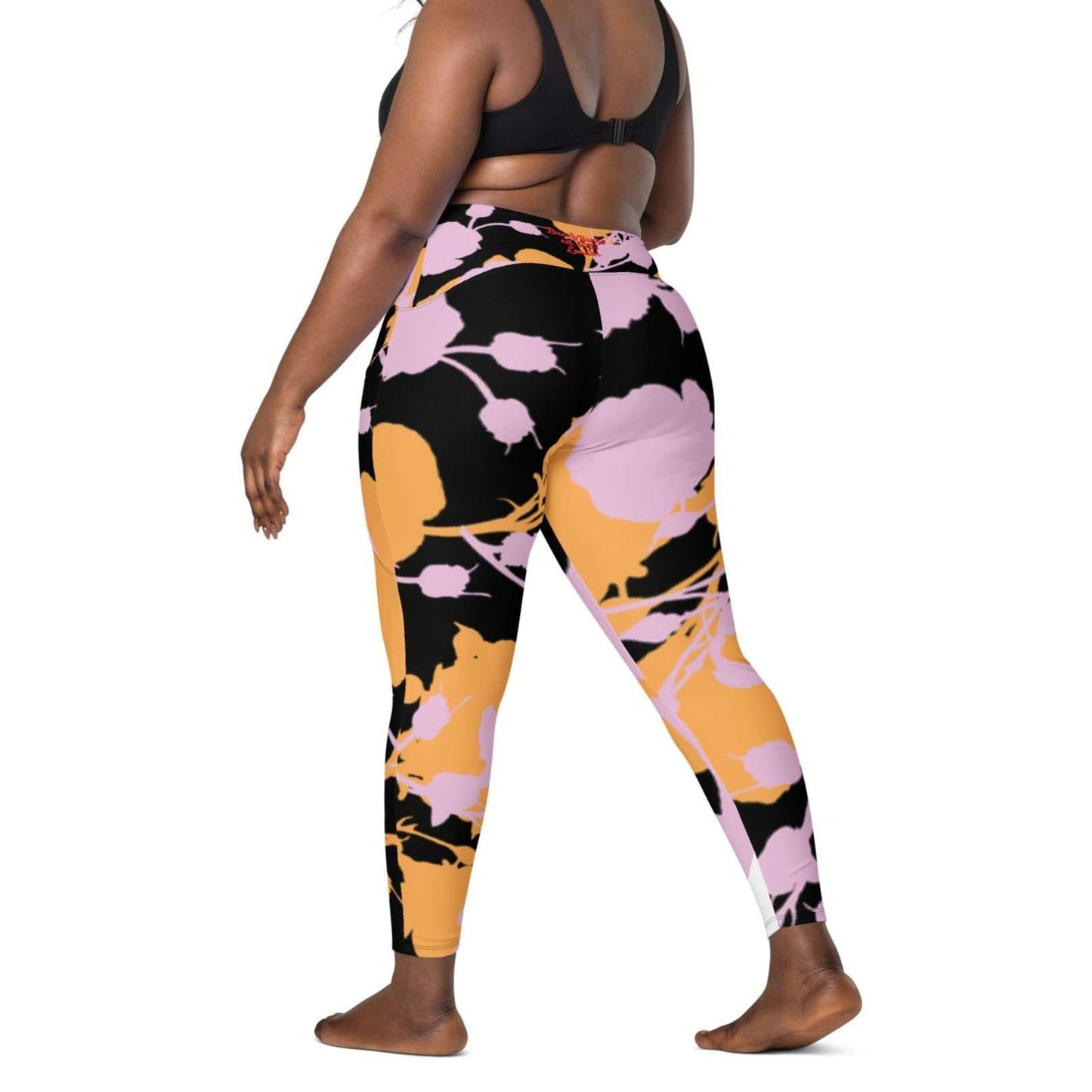 A model wearing The Miami Sculpt Leggings, showing the sculpting fit and the dynamic pink and orange splashes print on the black fabric.