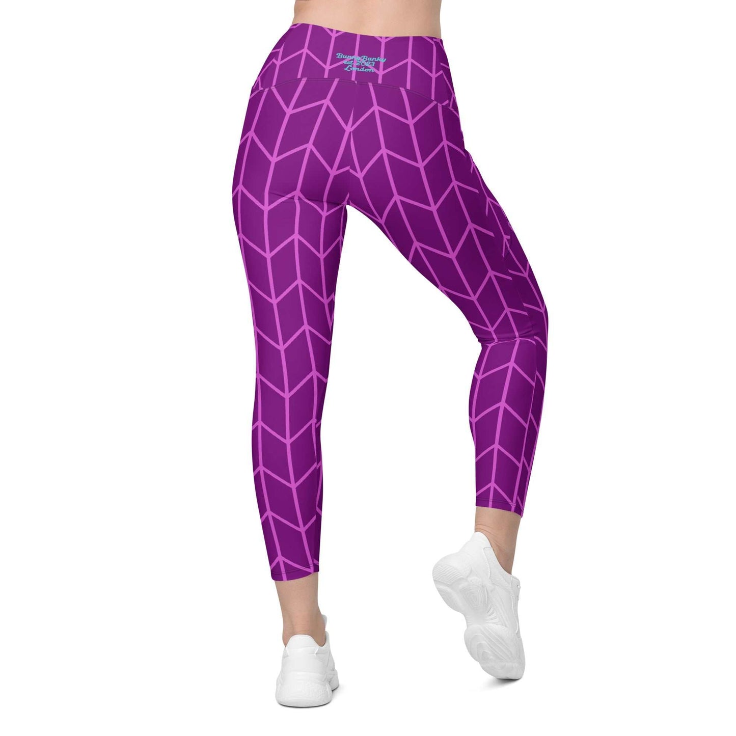 A close-up of The New York Sculpt Leggings, showing the purple and pink Art Deco print and the side pocket.