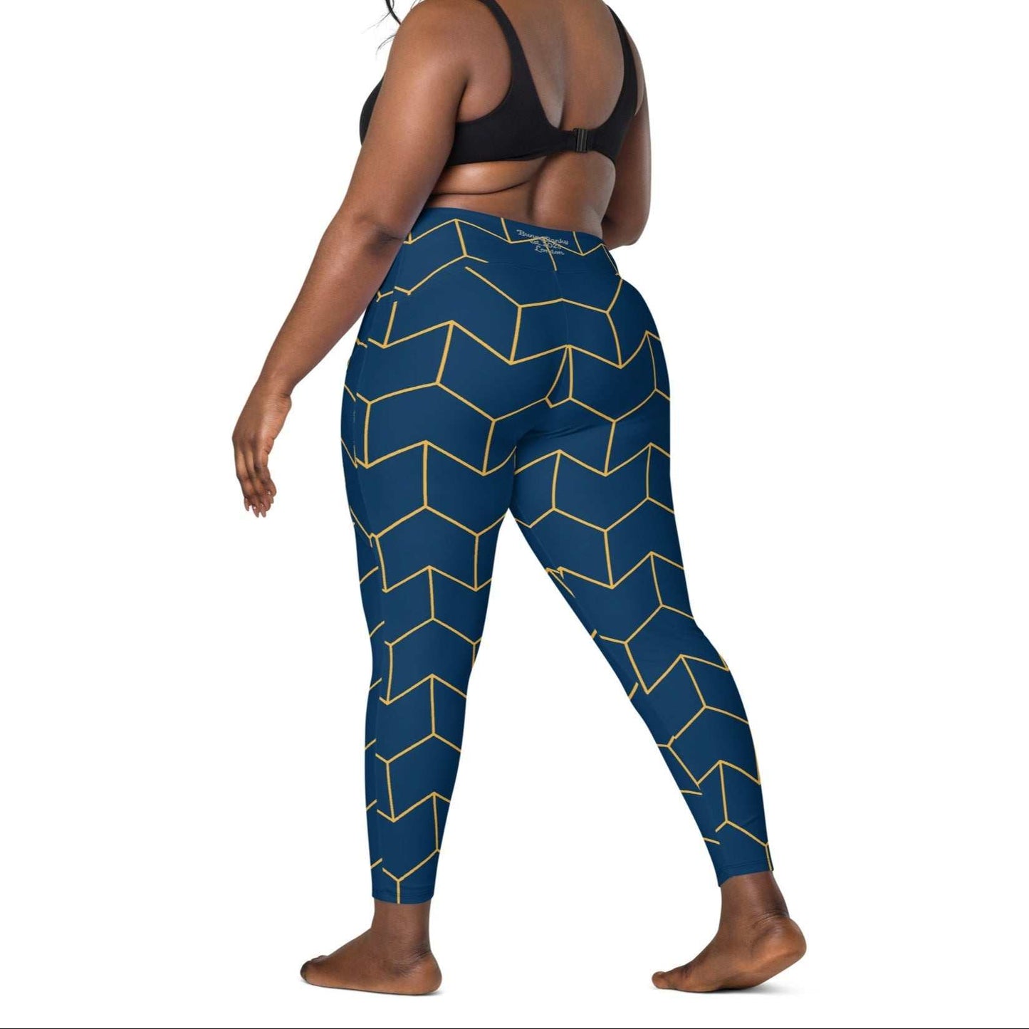 A model wearing The Barons Court Sculpt Leggings showing the matching navy and yellow Art Deco print.
