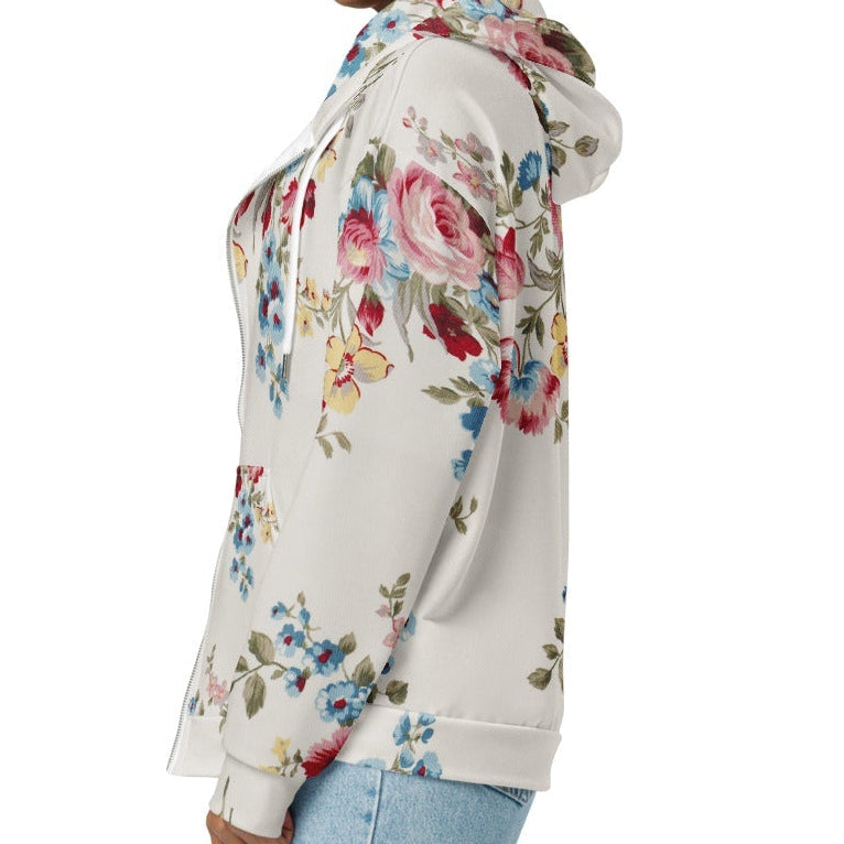 A model wearing The Pink Blush Zip Hoodie, showing the serene pink blush and sky blue floral pattern and the premium fit with metal zipper details.