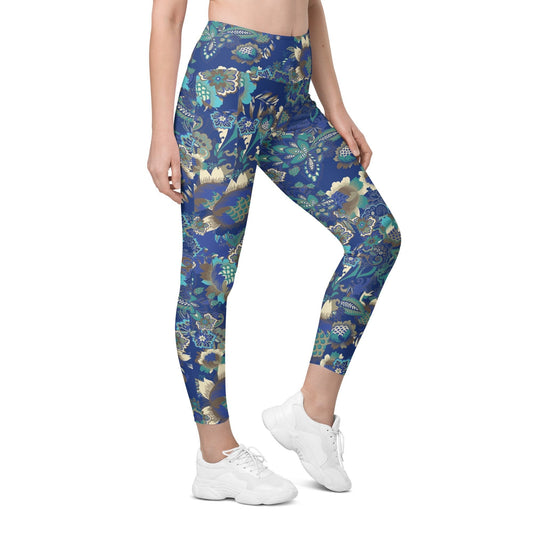 A model wearing the Rio Sculpt Leggings in the bright blue floral print, showing the flattering high-waisted fit and side pocket detail.