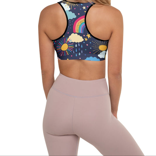 A model wearing the Riverside Performance Bra showcasing the dreamlike print of clouds, stars and rainbows on navy blue background and the racer back.