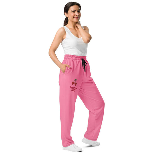 A model wearing The Seoul Pink Flow Wide Joggers, showing the wide-leg cut and the playful Pop Cherry print and binary code on the vibrant pink fabric.