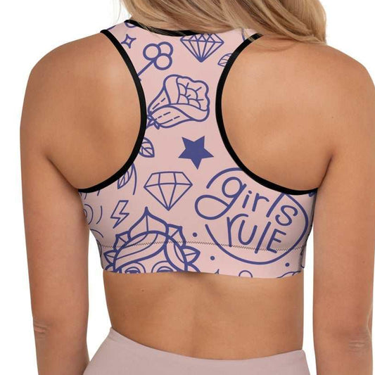 A model wearing The Sisterhood Performance Bra, showing the supportive fit and the high-impact "Girl Power" collage print.