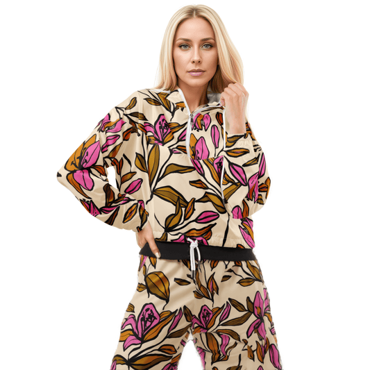 A model wearing The Terra Shell, showing the lightweight fit and the vibrant bubblegum pink tropical floral print on the beige fabric.