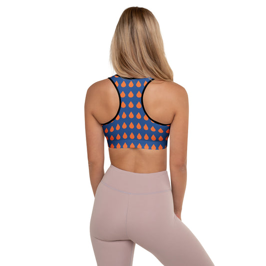 A model wearing The Thames Performance Bra, showing the supportive fit and the sophisticated orange drops print on the deep navy blue background. Highlights the garment's construction and the City Babe text printed in black on the top left