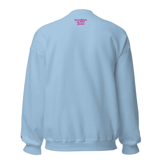 A close-up of The Upgraded Sweatshirt, highlighting the bold Upgraded text embroidered in fuschia on the chest, the soft air-jet spun fabric, and the detailed heritage logo print on the back.