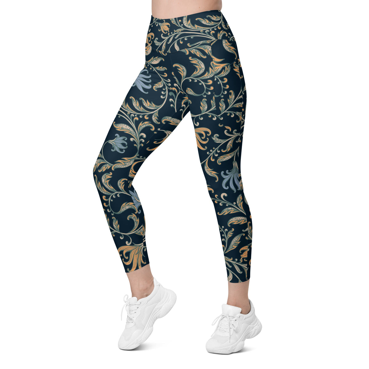 model wearing the Venice high-waisted sculpt leggings featuring an intricate gold and slate-blue floral filigree print over a dark blue base