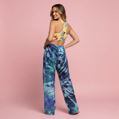 BunnyBankY AI Proprietary Model wearing the Toronto longline performance bra, and Athens Flow Wide Joggers. The set showcases the clashing prints.