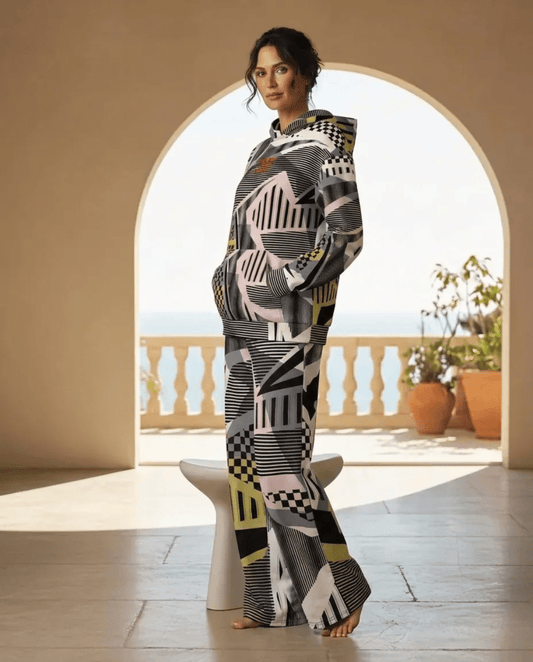 A BunnyBankY AI proprietary model wearing the full Sydney Set, featuring the oversized hoodie and matching wide-leg joggers. The image showcases the cohesive Art Deco pattern of monochrome checkerboards, pinstripes, and soft sand and blush tones in a high-fashion, relaxed silhouette.
