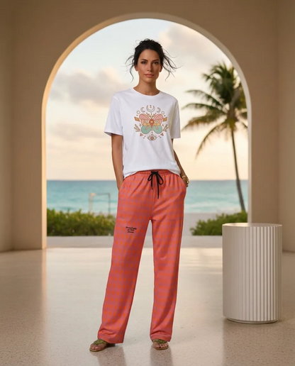 A BunnyBankY AI proprietary Model wearing the Revolution t-shirt and The Southwark Flow Joggers, showing the wide-leg cut and lilaxc and orange hues pattern