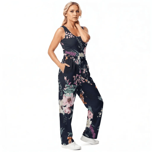Model wearing the Kew Botanical Performance Tank featuring pink  and beige floral pattern on blue fabric and matching relaxed Joggers.