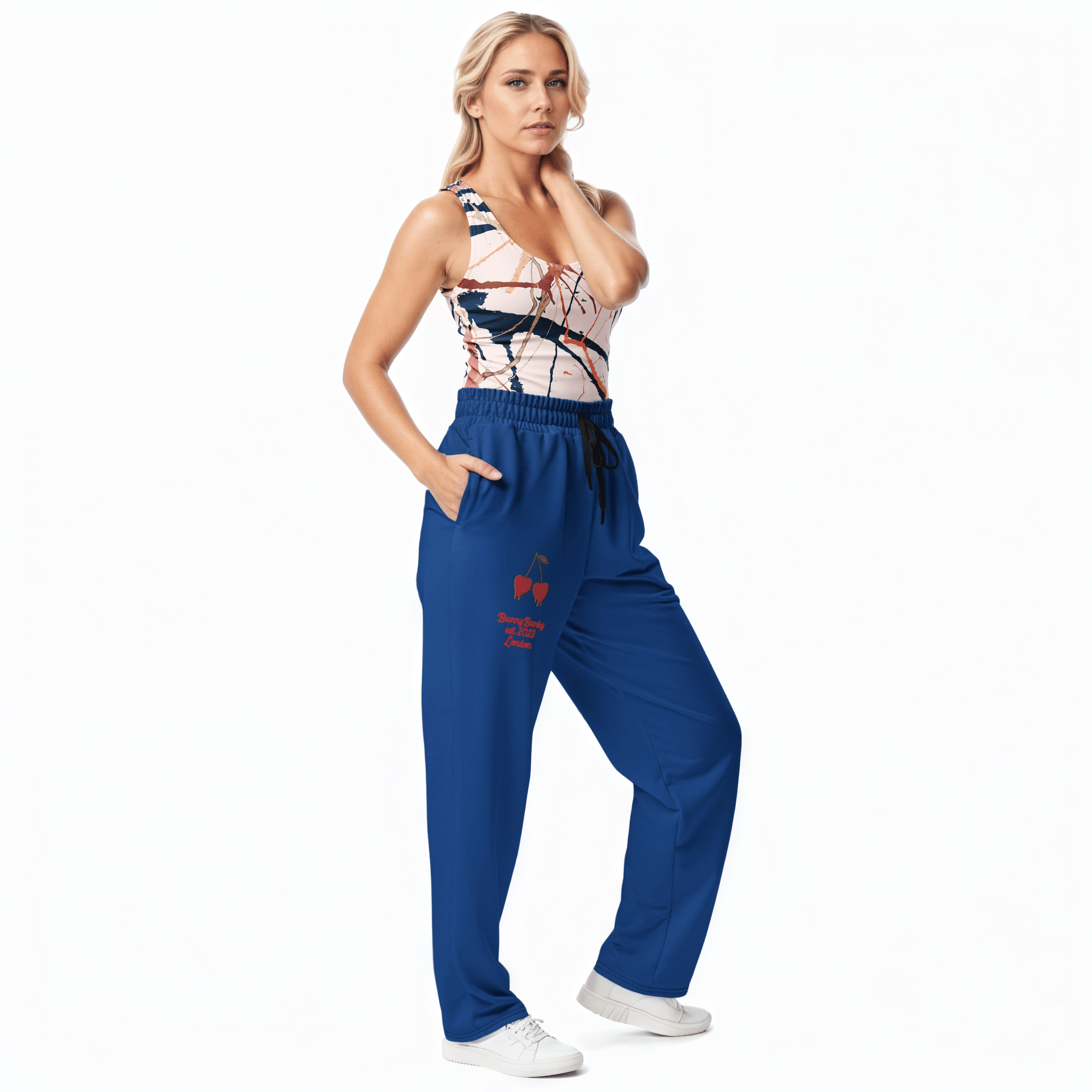 BunnyBanky AI proprietary Model wearing the Angel Performance Tank and The LA Navy Flow Wide Joggers, showing the wide-leg cut, the playful Pop Cherry print, and the binary code on the dark navy fabric.