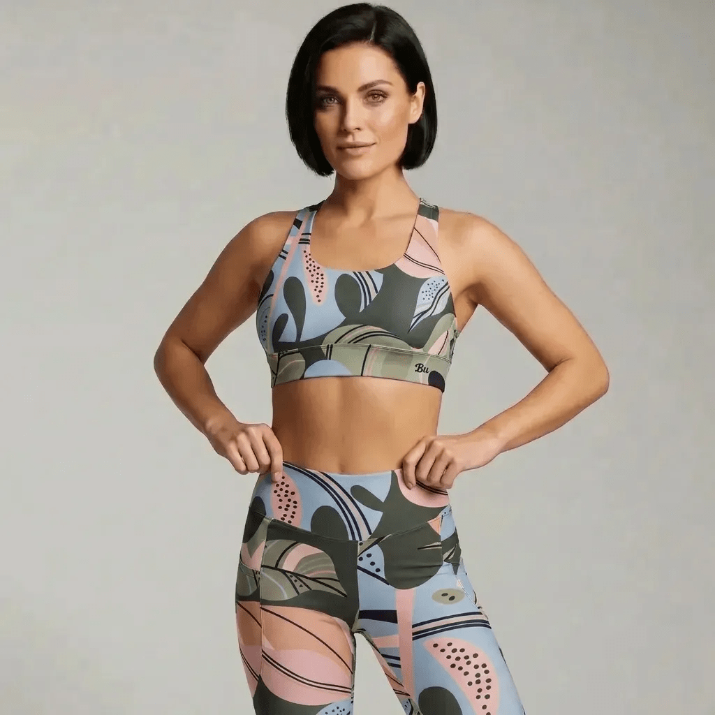 A model wearing The Barbican Sculpt Leggings, showing the sculpting fit and the pastel green and pink exotic flower print.