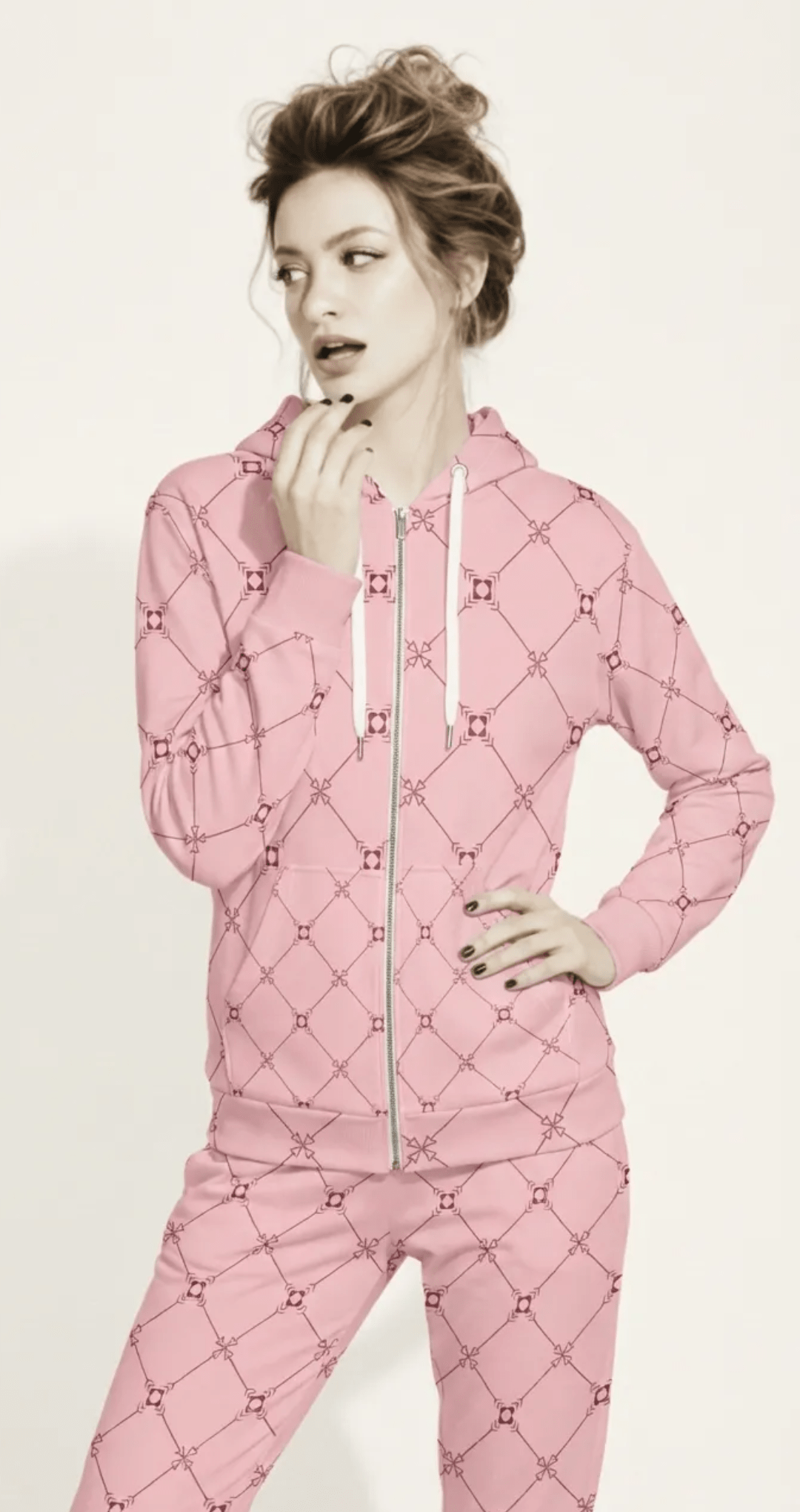 AI Proprietary Model wearing the full Mayfair  Set, showing the burgundy and pink geometric monogram print on both the zip hoodie and the slim fit joggers, emphasizing the cohesive, tailored look of the recycled polyester set.