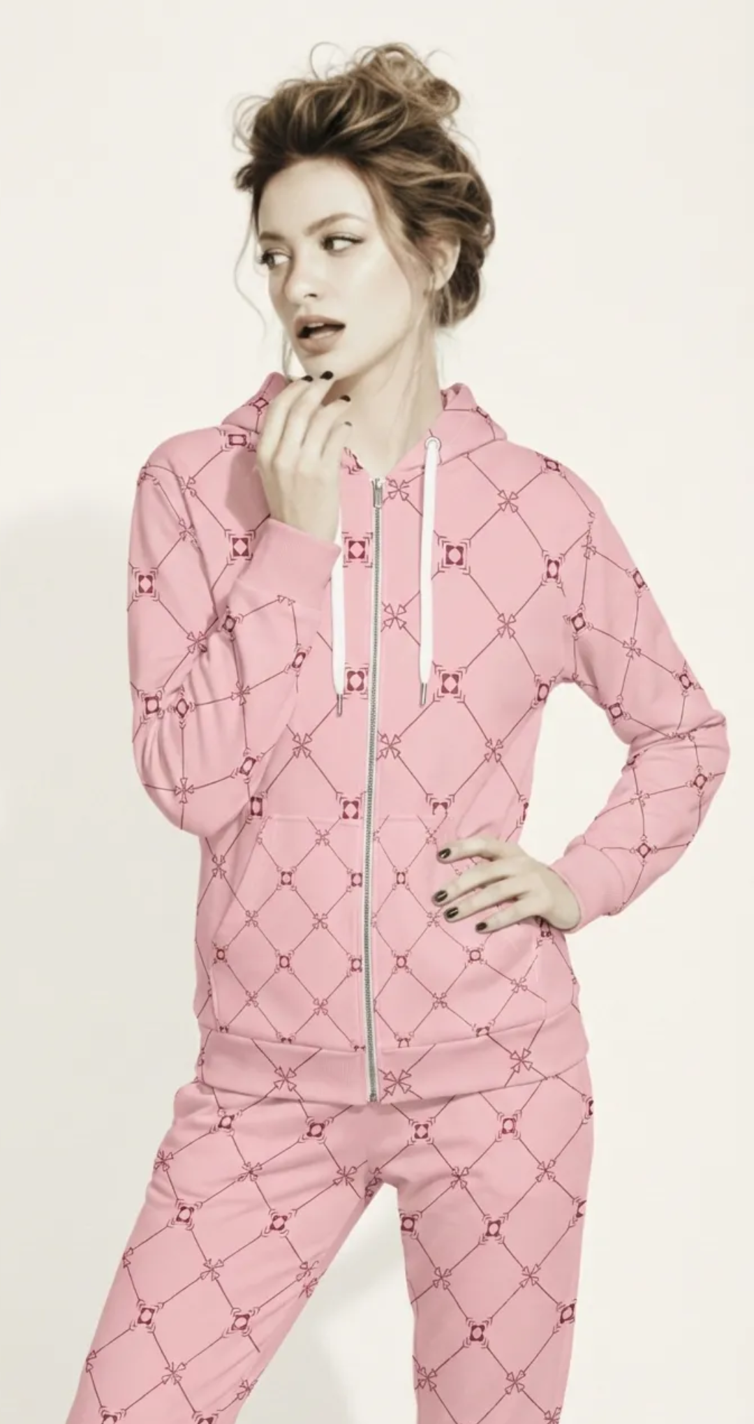 AI Proprietary Model wearing the full Mayfair  Set, showing the burgundy and pink geometric monogram print on both the zip hoodie and the slim fit joggers, emphasizing the cohesive, tailored look of the recycled polyester set.