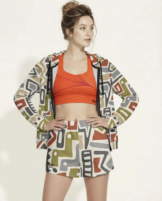 The complete Amsterdam Performance Set, and Rhodes longline performance bra worn by a BunnyBankY AI proprietary model. The image features the matching blue architectural print on both the athletic shorts and the zip hoodie for a coordinated urban look.