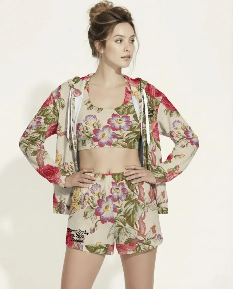 A BunnyBankY AI proprietary model wearing the Evergreen Zip Hoodie, showcasing the elaborate red rose and green vine vintage print on a sustainable cream fabric.