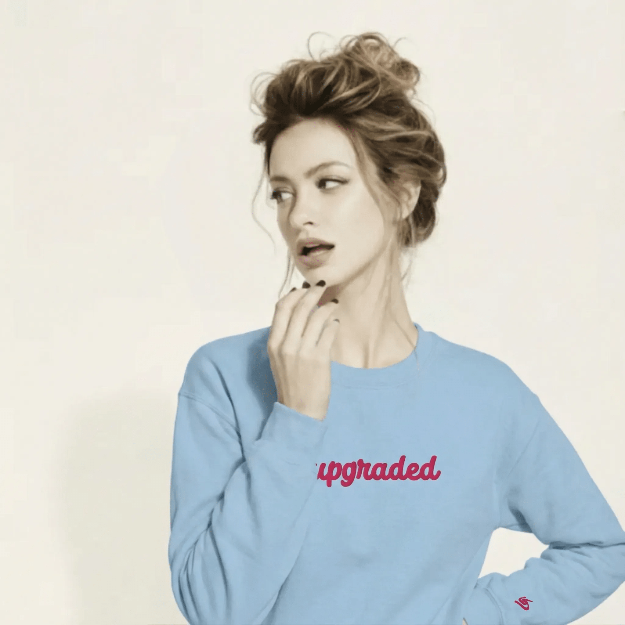 A BunnyBankY AI proprietary model wearing The Upgraded Sweatshirt, highlighting the bold Upgraded text embroidered in fuschia on the chest, the soft air-jet spun fabric, and the detailed heritage logo print on the back.