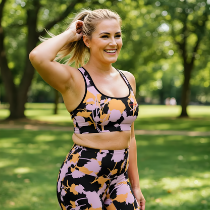 AI BunnyBankY model wearing The Miami Performance Bra, showing the supportive fit and the vibrant pink and orange splashes print.