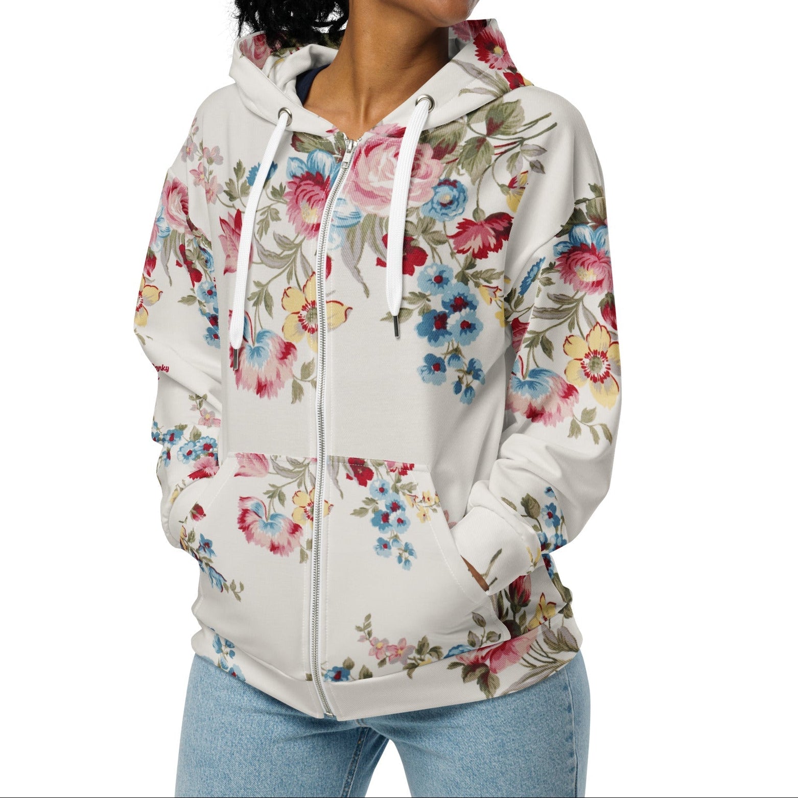 A model wearing The Pink Blush Zip Hoodie, showing the serene pink blush and sky blue floral pattern and the premium fit with metal zipper details.