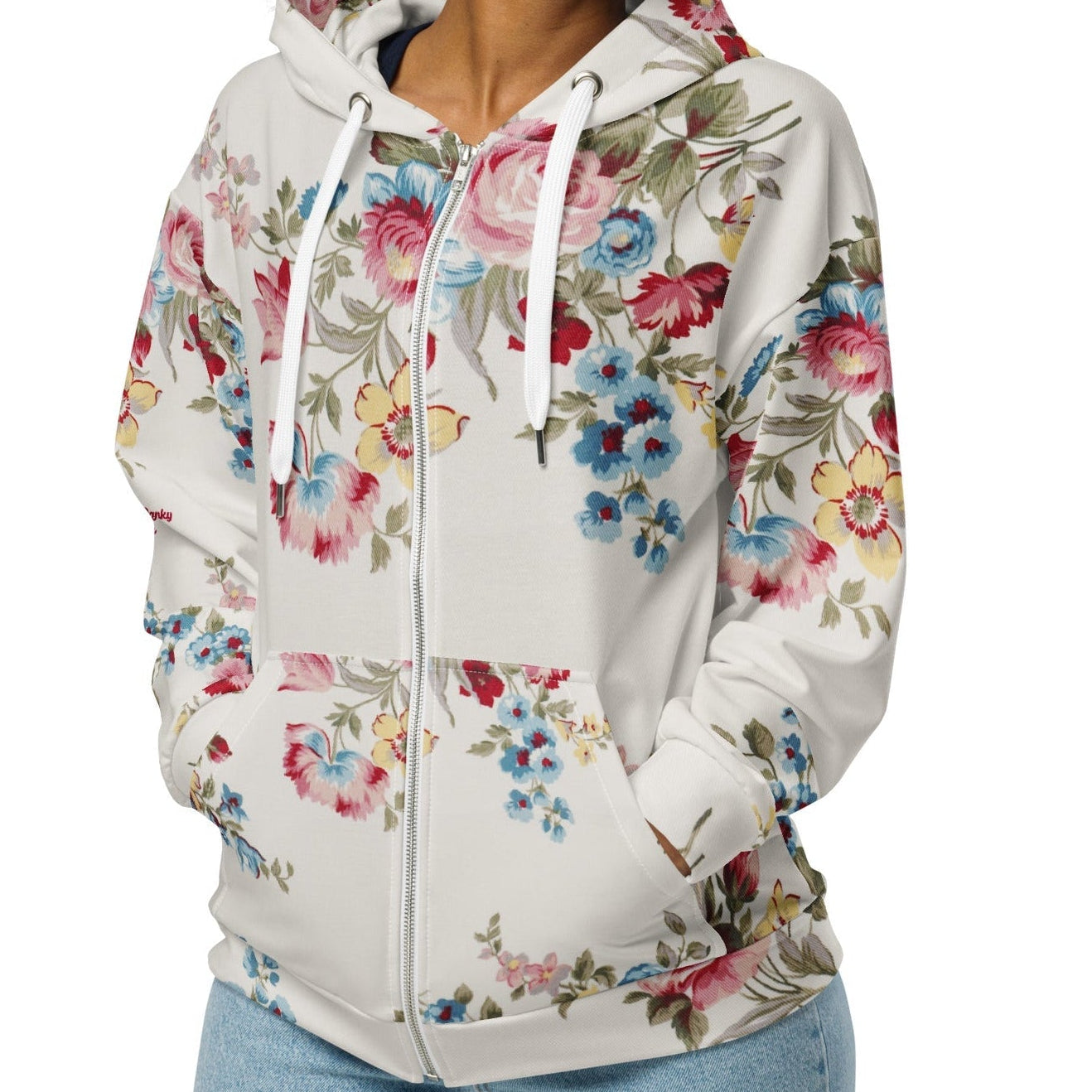 A model wearing The Pink Blush Zip Hoodie, showing the serene pink blush and sky blue floral pattern and the premium fit with metal zipper details.