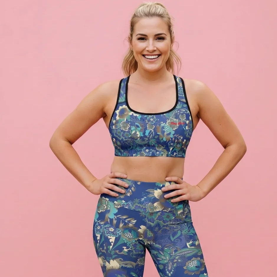 AI Proprietary Model wearing the full Rio Set, showing the supportive fit of the Performance Bra and the high-waisted Sculpt Leggings. Highlights the vibrant bright blue floral print and the 74% recycled polyester material.