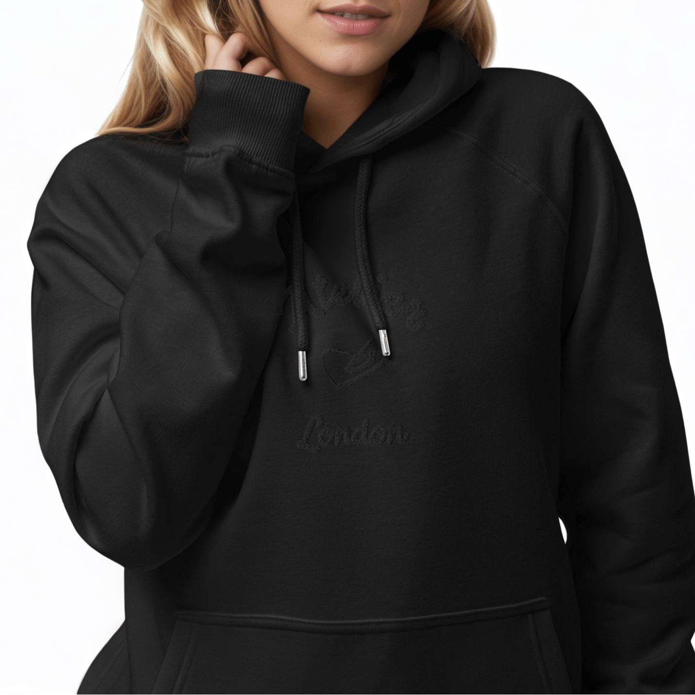 A model wearing The Atelier Hoodie showing the branded atelier heart logo