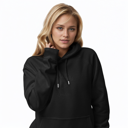 A model wearing The Atelier Hoodie showing the branded atelier heart logo