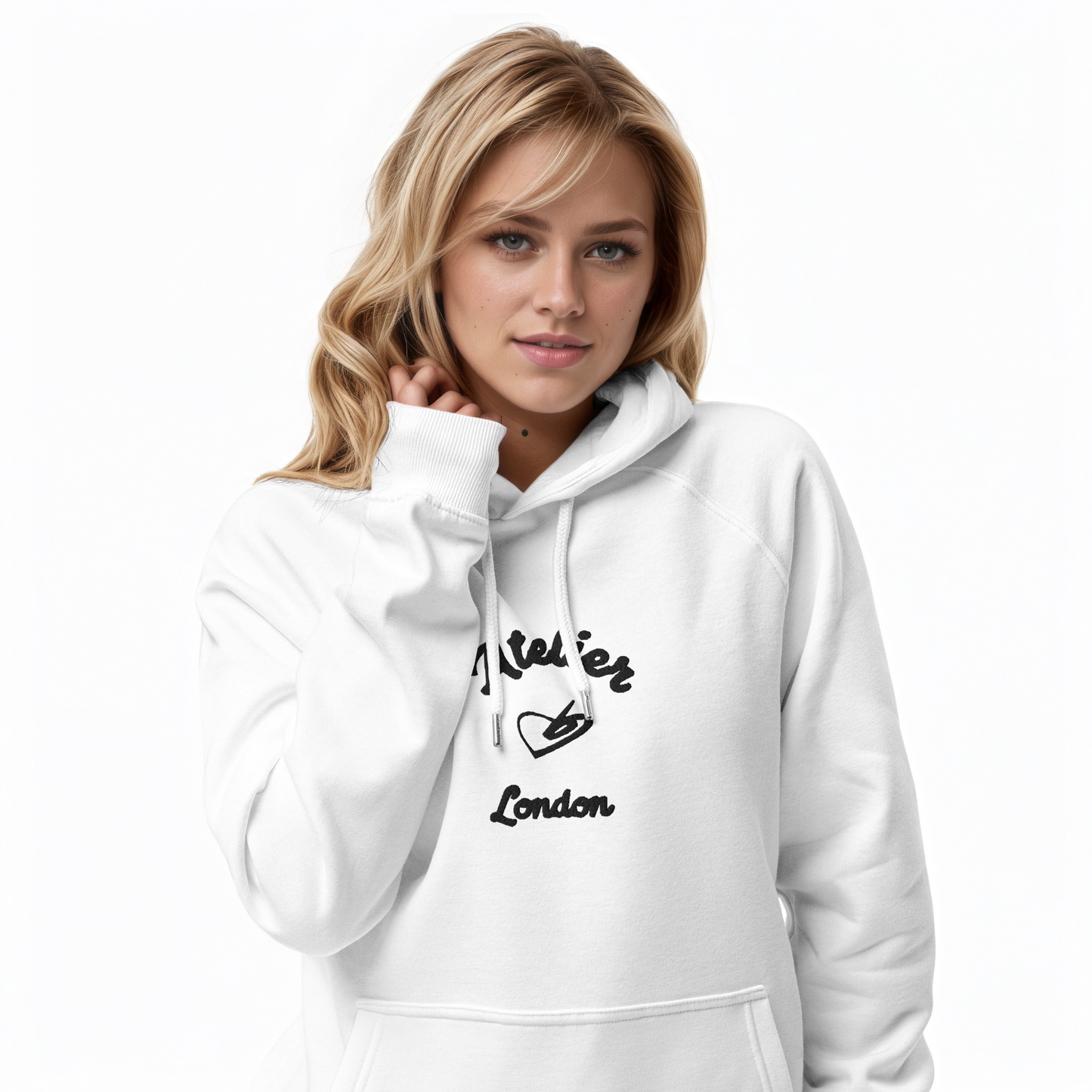 A model wearing The Atelier Hoodie showing the branded atelier heart logo