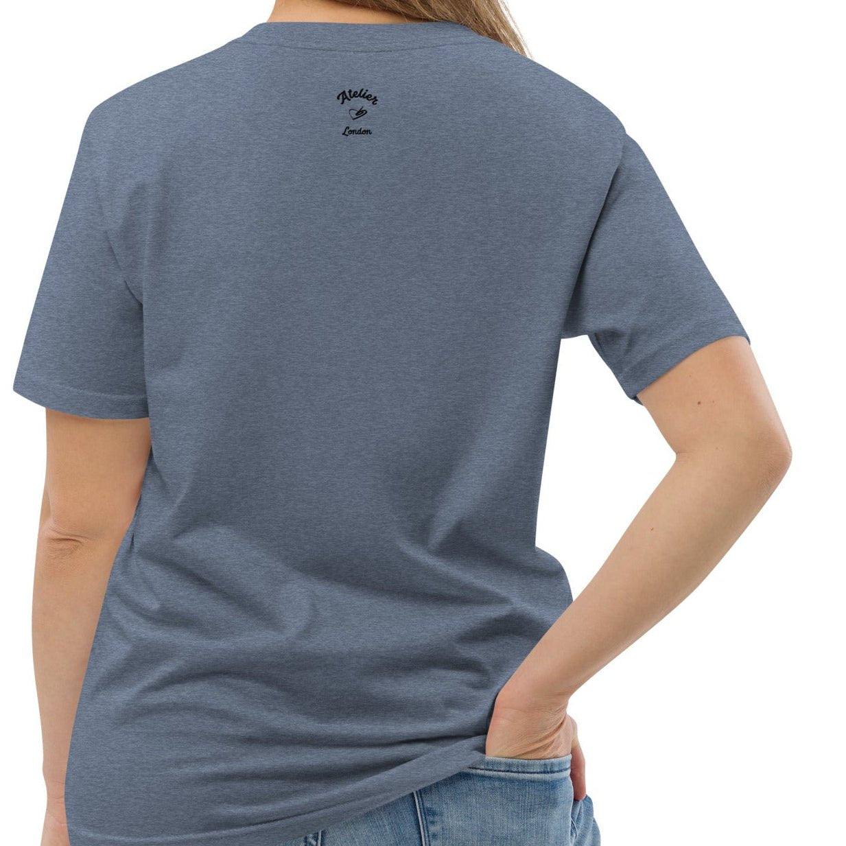A denim blue organic t-shirt featuring a symmetrical graphic of two colorful seahorses with bunny ears and floral details.